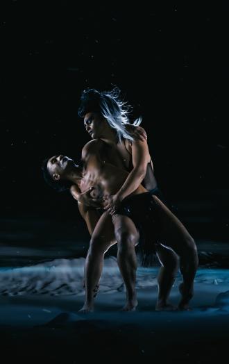 Two dancers embrace each other 