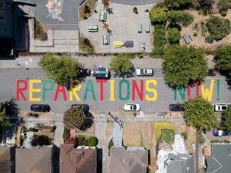 Reparations Now! colorful mural painted on residential street in South Berkeley.